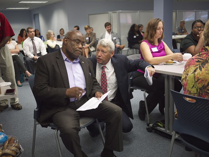 Allen Lomax and Mayor Bill Euille confer at the Partnership meeting.
