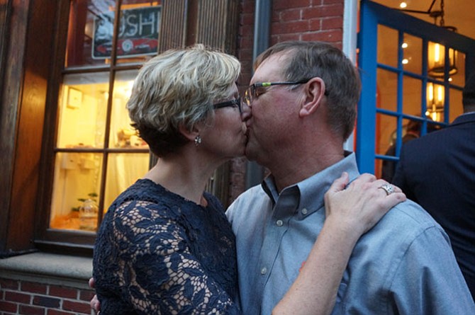 Rick and Elizabeth Myllenbeck share a celebratory kiss after the ribbon cutting at Sonoma Cellar at 207 King St.  in Old Town.
