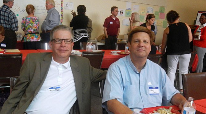 Enjoying the luncheon program are Pastor Brent Thalacker (at left) of Nativity Lutheran Church and Pastor Robert Lewis of Messiah Lutheran Church.
