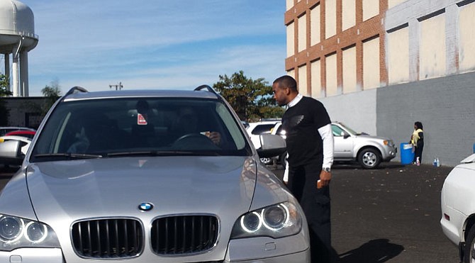 Reginald and Linnett Scott were surprised when Pastor Howard-John Wesley (pictured) approached their car window offering a voucher for a free car wash. Wesley, alongside ASBC members, distributed free vouchers and doughnuts at Yates Carwash and Detail Center. 
