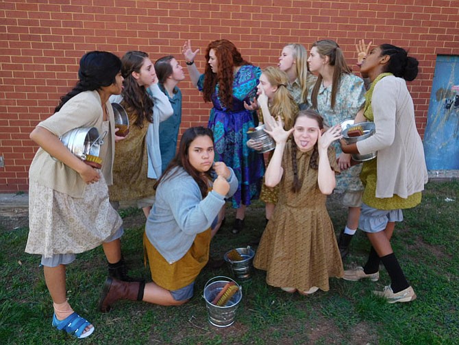 The orphans give Miss Hannigan (in blue dress) a hard time. (Standing, from left) are Paayal Chandra, Caroline Woodson, Maggie Shircliff, Grace Mattes (as Hannigan), Emily Cason, Shannon Gaskins, Melissa Kapfer and Blen Yohannes. (Kneeling, from left) are Adriana Castillo and Caitlyn Valenza. 

