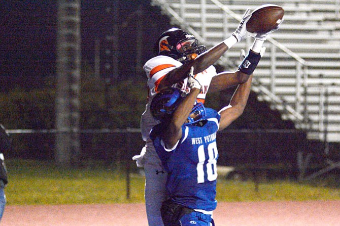 West Springfield receiver Daniel Adu leaps over a West Potomac defender to bring in a 10-yard touchdown reception with 6 seconds remaining in the first half of Friday’s win over West Potomac.