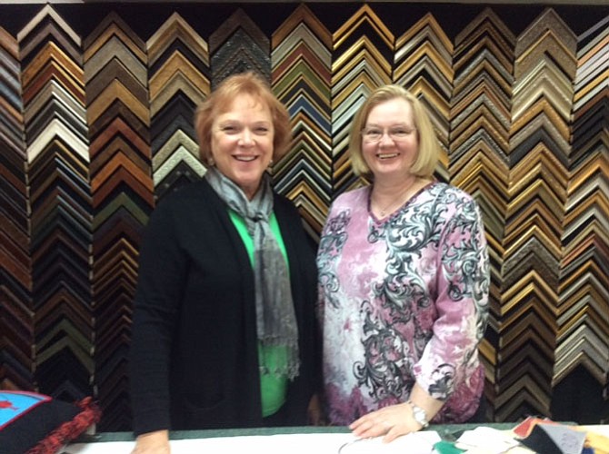 In Stitches Needlework owner Ellen Meyer (left) of Alexandria and shop manager Patricia Eaton (right) of Haymarket celebrate the 20th anniversary of the shop.