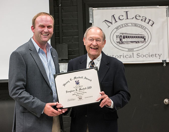 Paul Kohlenberger, president of the McLean Historical Society, presents the Henry C. Mackall Award for Local History to Doug Mackall (right).
