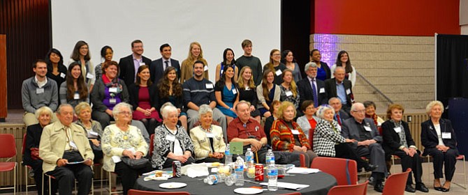 Taking the stage for a group photo with the honored guests Holocaust Survivors up front and the Students Ambassadors and members of Mason Hillel in the back at the third Expressions of the Holocaust: Memories event at George Mason University.