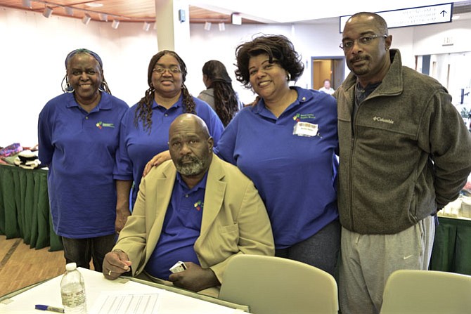 Juanita Davis, Winnie K. Burns, Anita Helm and Embry Rucker Shelter director Vincent Jenkins stand with Resurrection Baptist Church Pastor William D. Helm. The Church hosted the “Stand Up for Our Homeless Community” outreach event at the Reston Community Center.