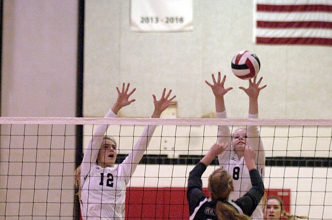 McLean’s Sierra Spraker (12) and Maddie McArthur attempt to block a Washington-Lee attack on Monday night.