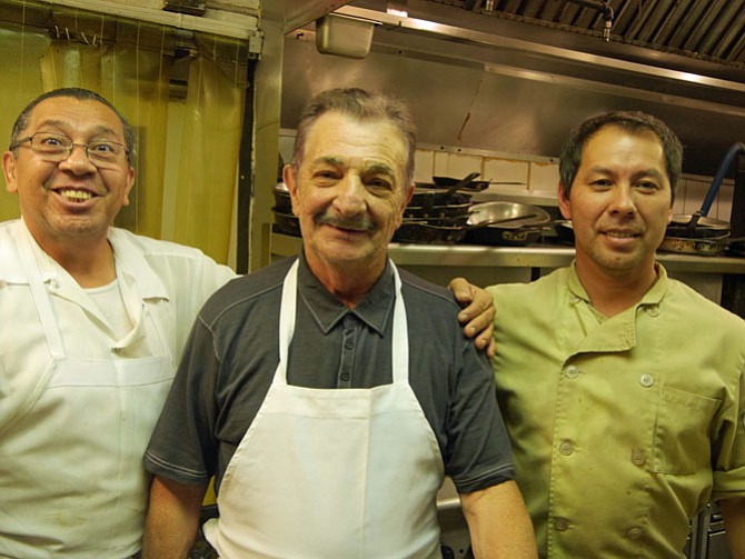 Chef Francesco Abbruzzetti (middle) takes a short break between customer orders with his chefs Victor Rivera (left) and Juan Amador (right).
