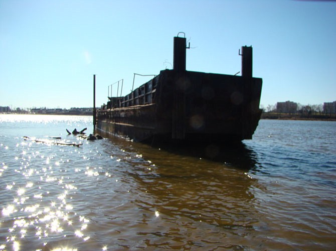 The abandoned barge in Belmont Bay was last used to haul materials for constructing the Fairfax Yacht Club in the 1980s.