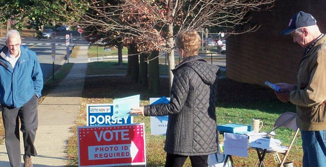 Betty Adelman and Bob Dunphy greet, and thank, arriving voters.
