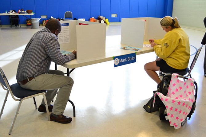 Overlee Knolls precinct voters at the Reed-Westover Building fill out their ballots.