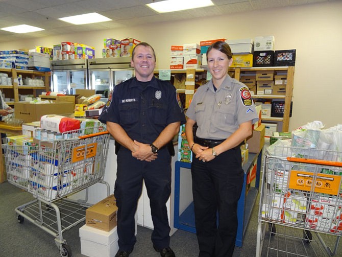 ully District Police Department, November 2014: PFC Tara Gerhard, Sully District Police Station food drive coordinator, and another officer deliver food to WFCM’s pantry after sponsoring 30 families for Thanksgiving in 2014.
