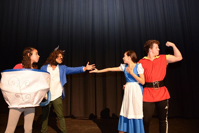 From left, seventh grader Valentina Mendoza as “Chip”, junior Chad Vann as “Beast”, freshman Taegan Chirinos as “Belle” and senior Hank von Kolnitz as “Gaston” in Hayfield Secondary School’s production of Disney’s “Beauty and the Beast.”