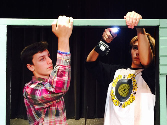 Quinn Partee and Ben Goodson take down the set after rehearsal Sunday at the Langley School.