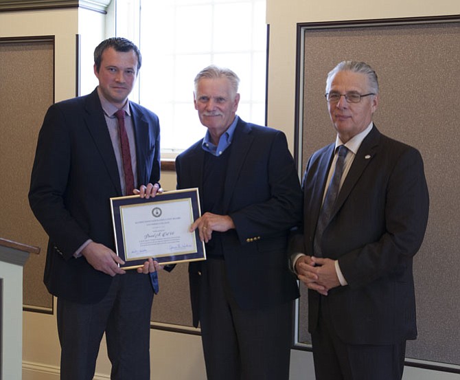 Christian H. Shaffmaster ’05, member of the alumni association executive board, (left), and Lycoming College President Kent C. Trachte (right) present David A. Oot ’66 with his award.
