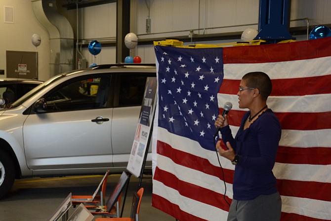 U.S. Marine Corps veteran and current art student Dani Figueroa of Alexandria speaks at the Springfield Progressive Service Center and receives a donated Toyota Rav4.