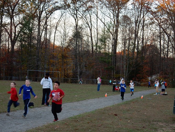 Students from the second to sixth grades run together, challenging their 'personal goals' of the day. Cheerful young students persevere despite the chilly temperature.