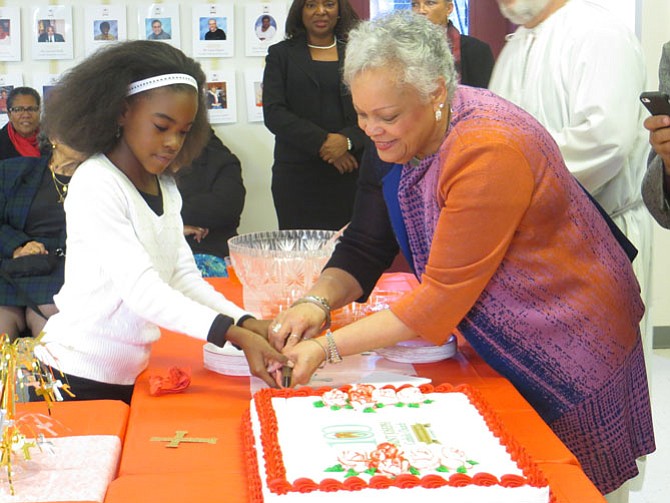 Aniya Mitchelle (left) cuts into cake at the reception with Beverly Thorton (right)
