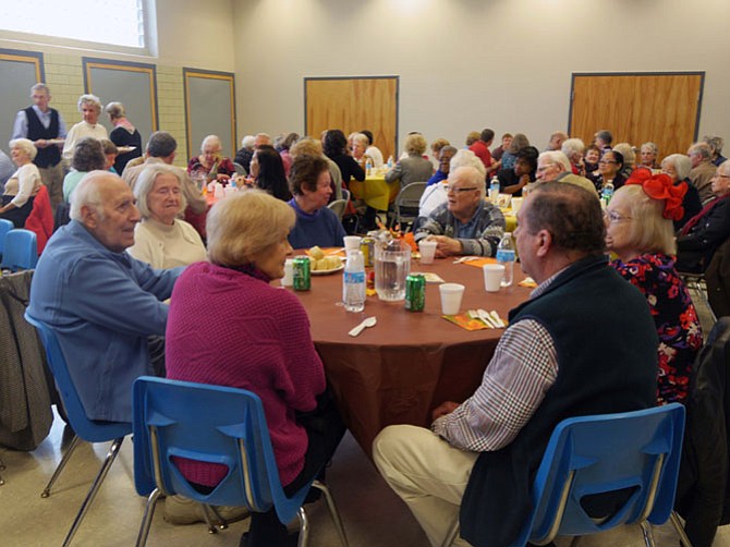 The tables are over half full at 12:30 p.m. waiting for the annual Thanksgiving meal to begin at 1 p.m. at Lee Senior Community Center. The room is alive with conversation with an overflow crowd of more than 100 people. Available chairs run out before the lunch has been set on the buffet table, and people crowd together making room for late comers.  A full Thanksgiving meal was served by volunteers from turkey to the cranberry sauce.
