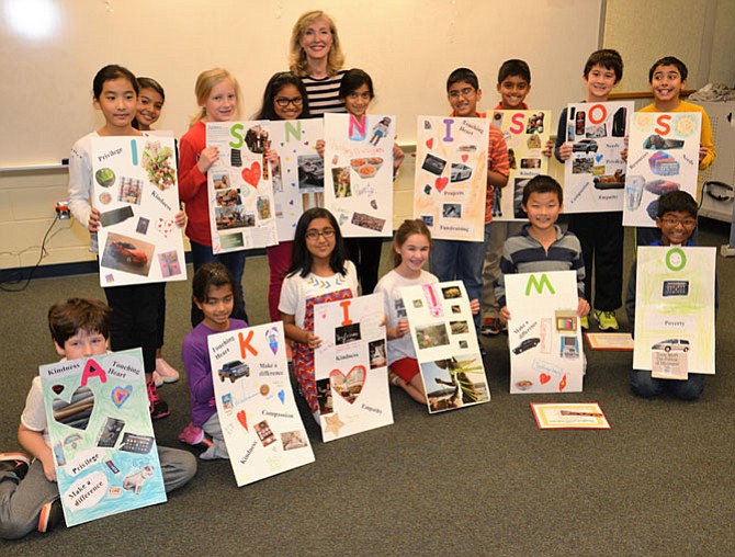 The Floris Elementary School Touching Heart young philanthropists pose with the posters they made to describe their experiences in the workshop where they made contact with orphans in Kenya, made sandwiches for the homeless and scarves for kids in foster care in Fairfax County. Coach Meg Chow [back row] tried, but things get a bit hectic at the end and the spell-out of “Kids on a Mission” just a bit jumbled - but still good-hearted.
