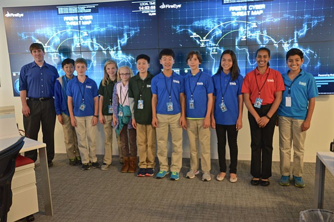 Members from The Nysmith School’s three CyberPatriot Competition teams visited FireEye cyber security company in Reston. The tech savvy students posed with FireEye staffer David Lindquist in front of the “threat map” in the company’s local operations command center.