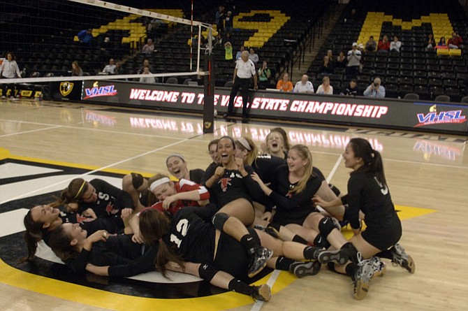 Madison volleyball players celebrate their five-set victory over Langley in the 6A state championship match on Nov. 20 at VCU’s Siegel Center in Richmond.