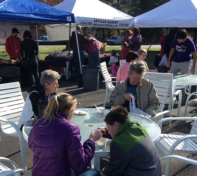 Farmers market shoppers enjoy venison cuisine as they learn about deer management strategies.