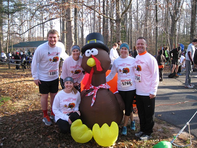 Runners pose with the inflatable turkey before the race begins.
