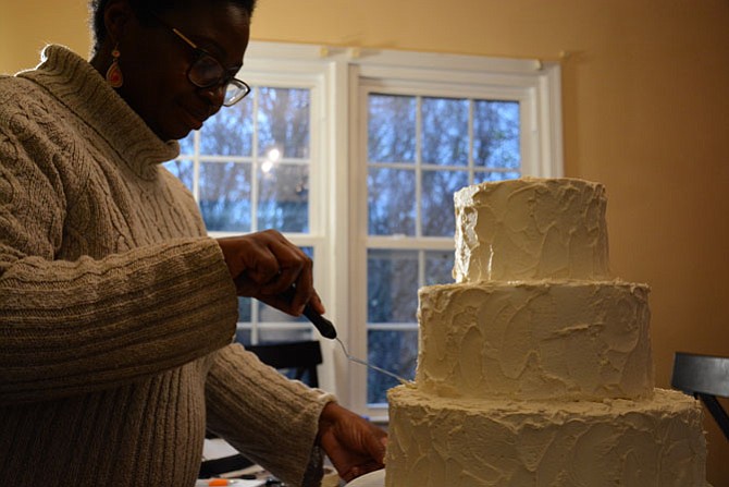 TaMeisha Norris, owner of allergy-friendly bakery Out of the Bubble, frosts a “dummy cake” used for display in her Springfield dining room.