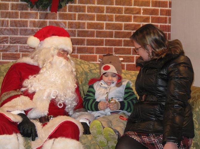 Visiting with Santa are Jackson Whitt, 4 1/2, with his mom Cheryl of Great Falls.
