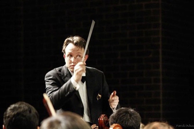 Director Scott McCormick conducts the Philharmonic orchestra.
