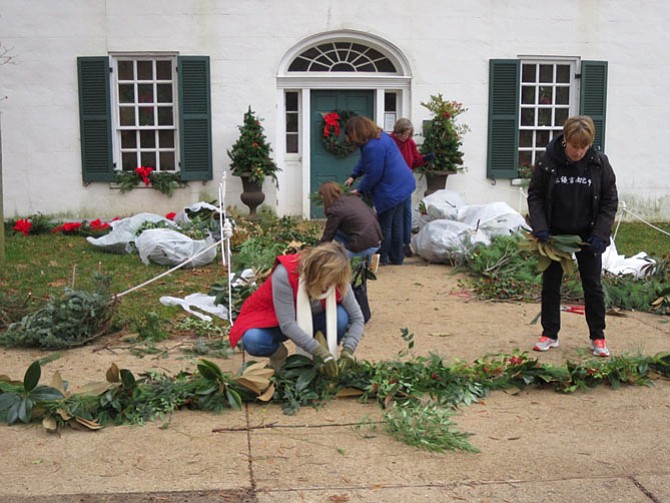 Deb McDonald is in the foreground. Wendy Band is in the brown jacket, Regina Kunkle is wearing the blue jacket, Sally Schlein is in the background wearing the red jacket. Suzanne Eastman is off the right of the photo wearing a blue jacket with lettering.
