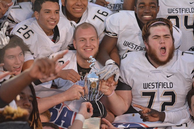 Members of the Westfield football team celebrate winning the 6A North region championship following a 40-8 victory over South County on Dec. 5.