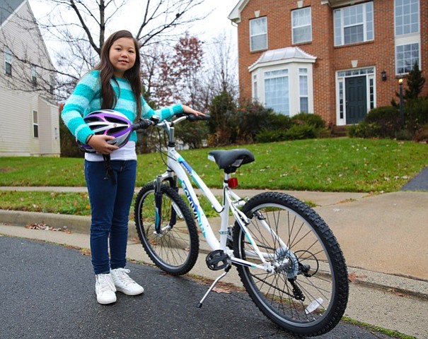 Elise Davidson with her new Schwinn bicycle, helmet and bell--prizes for winning the Saris Bicycle Poster contest.
