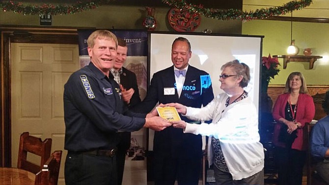 Steve Mayer (left) accepts the second place Mary Thonen Highway Beautification Award from Vicki McLeod (right) recognizing his Sunoco station on Richmond Highway.
