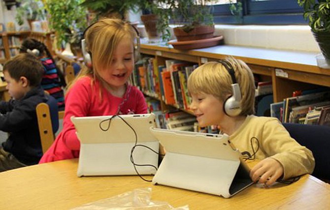 Churchill Road kindergarteners Libby Lehnert and Gavin ten Siethoff share their coding successes with one another during their Hour of Code lessons.