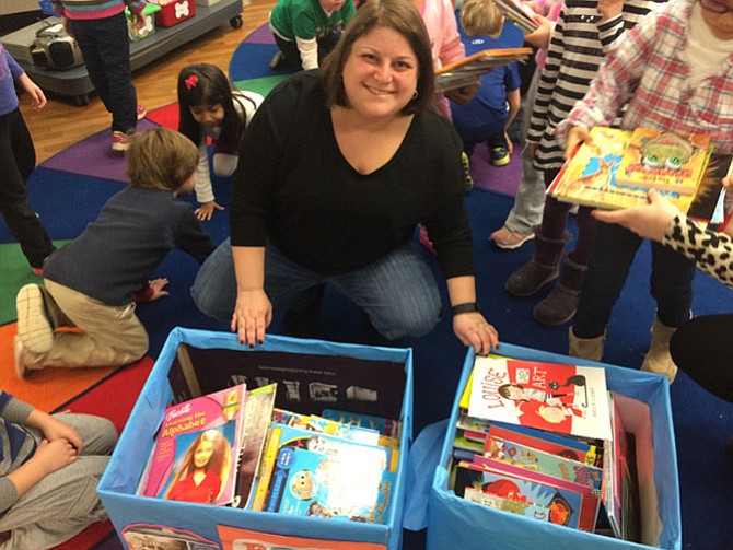 Geneva School kindergarten teacher Debra Lieberman packs up book donations.
