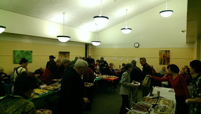 Community members sample a variety of food from local restaurants at the 2015 Taste of Braddock on Dec. 9.