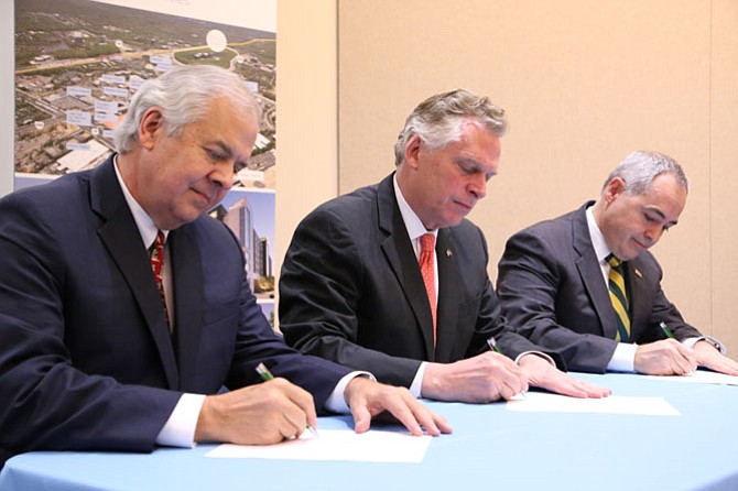 Inova CEO J. Knox Singleton (from left), Gov. Terry McAuliffe, and George Mason University president Ángel Cabrera at a news conference announcing a strategic partnership between Inova and George Mason University. 
