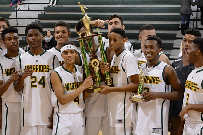 Members of the Wakefield boys’ basketball team celebrate winning the George Long holiday tournament on Dec. 30.