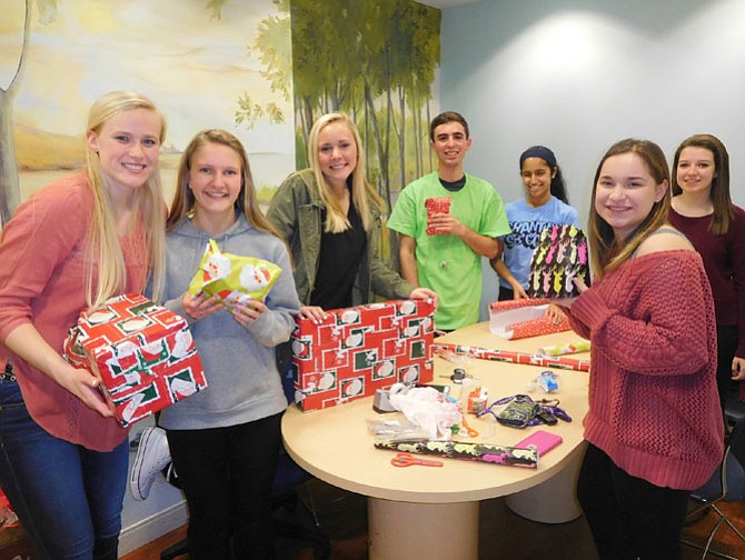 Students wrapping the children’s Christmas gifts are (from left) Madison Cochran, Briley Rickard, Maddie Aldrich, Zach Cohen, Izzy D’Souza, Rachael Jackson and Shannon McCullough.
