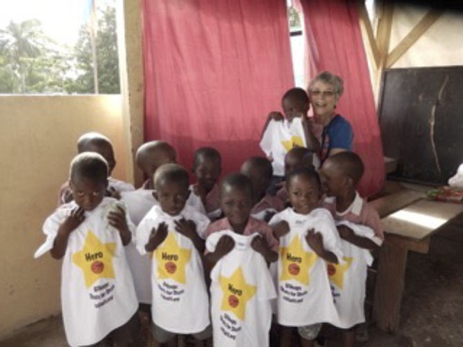 Emelie Parker of CCH and some Haitian students in their Shots for Shots T-shirts.
