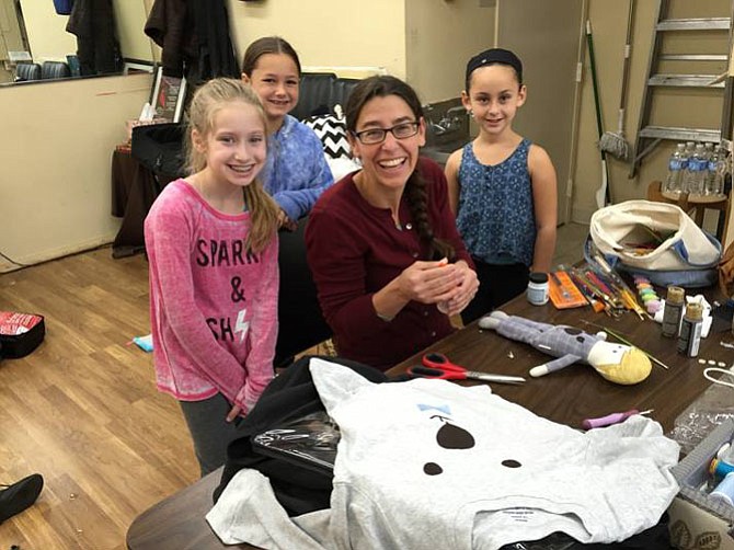 Sharon Alexander, the “Peter Pan” costumer, at work with Fairies in the show, from left, Emily Ashman (Silvermist), Lexi Blank (Rosetta) and Vidia (Rachel Reinstein). 
