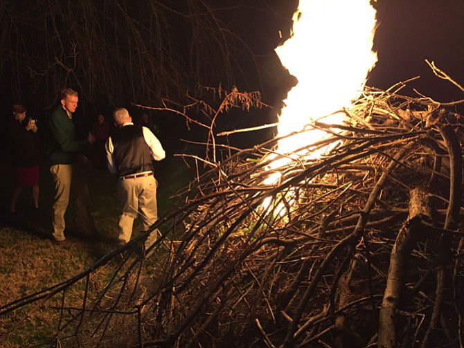 Bill Conway with son Will as the bonfire starts during the family’s annual Christmas party.
