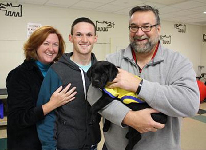 Susan, Zachary and Michael Kehoe with puppy Lennon. The Kehoes of Clifton are raising Lennon for Canine Companions for Independence.
