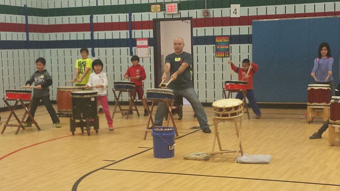 Instructor Mark Rooney, center, shows students how to play taiko. The opportunity was made possible through a grant from the Japan Foundation, which teachers at Fox Mill applied to back in June 2015. The afterschool session took place in late November 2015. 
