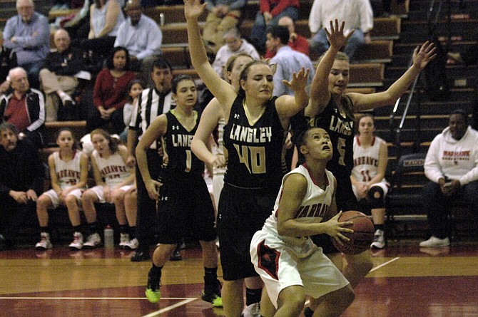 Stephanie Sipple (40), Sarah Flatley (5) and the Langley girls' basketball team held Madison without a field goal for the first nine-plus minutes of Friday's contest.