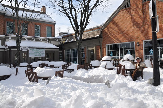 Doug Stevens enjoys some hot coffee in Potomac Village among the snow drifts.
