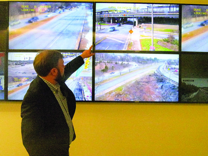 Jeff DuVal, deputy director of operations for the City of Alexandria’s Department of Transportation and Environmental Services, indicates an intersection monitored in real time by one of 11 traffic cameras in the Snow Control Center. “On King and Dangerfield we get a pulse for traffic and pedestrians in and out of the metro station,” he said.
