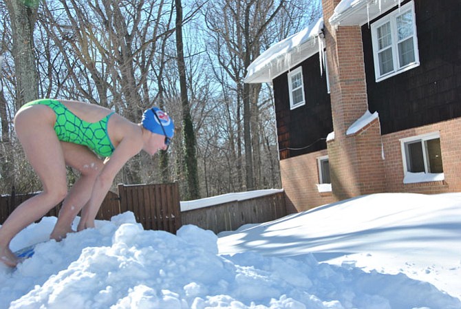 Bereft a pool that is open, Caroline Wittich of Springfield, also a member of the West Springfield Spartan Swim and Dive team, works on her start.
